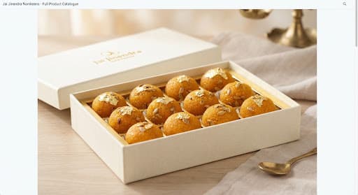 Motichoor laddus garnished with gold leaf in a gift box